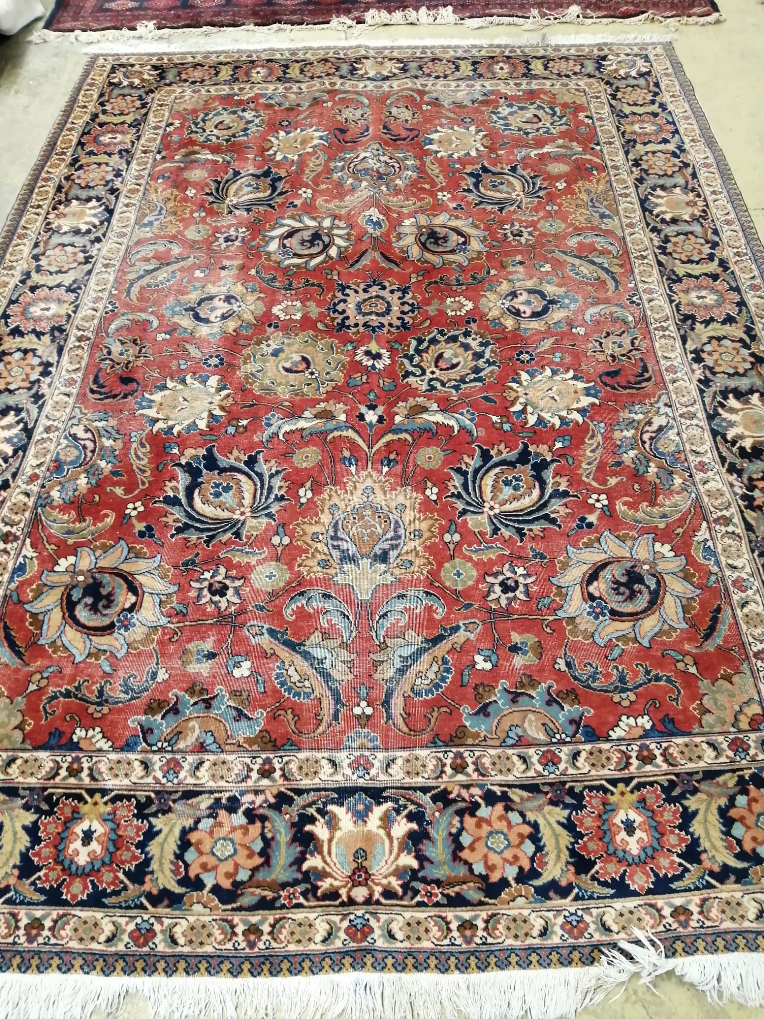 An Heriz red ground floral carpet, 310 x 226cm